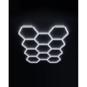Eleven interconnected illuminated white LED hexagon garage ceiling lighting grids on dark background